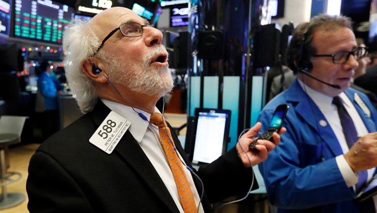 Traders Peter Tuchman, left, and Sal Suarino work on the floor of the New York Stock Exchange.