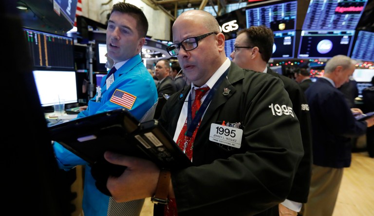 Specialist Thomas McArdle, left, and trader Jeffrey Vazquez work on the floor of the New York Stock Exchange, Monday, Dec. 3, 2018. Stocks are opening sharply higher on Wall Street, following gains in overseas markets after the U.S. and China struck a 90-day truce in their trade dispute.