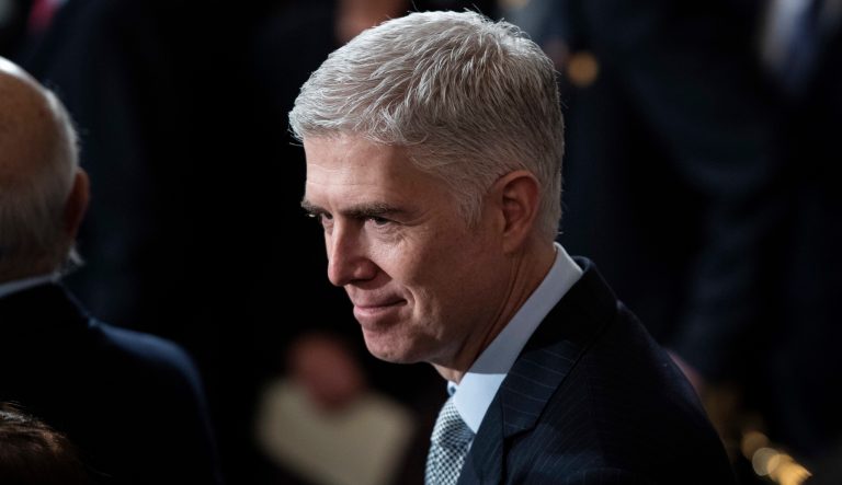 Supreme Court Associate Justice Neil Gorsuch waits for the arrival of the casket of former President George H.W. Bush carried into the Capitol on Capitol Hill in Washington, Monday, Dec. 3, 2018. 