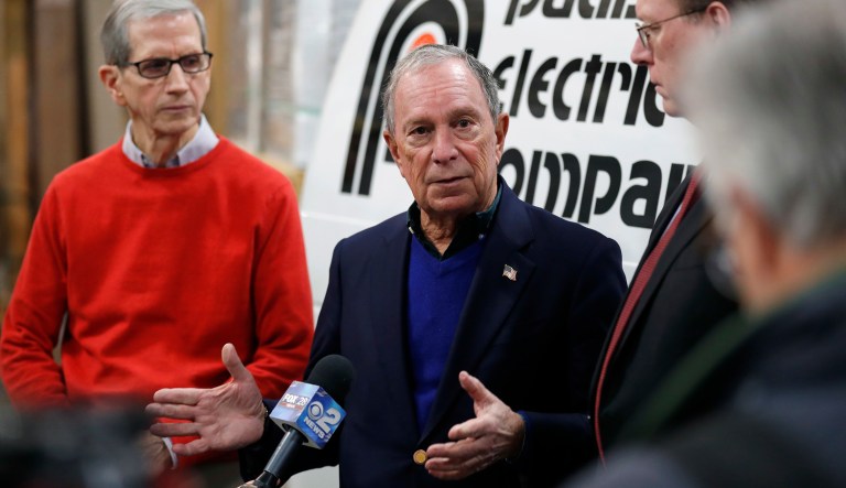Former New York City Mayor Michael Bloomberg, center, speaks during a news conference after touring the Paulson Electric Company, Tuesday, Dec. 4, 2018, in Cedar Rapids, Iowa.