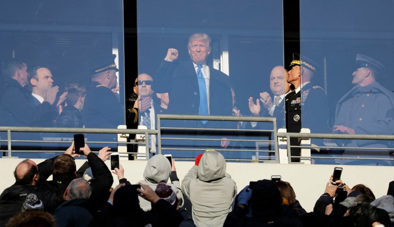 In this Saturday, Dec. 10, 2016, then President-elect Donald Trump acknowledges spectators during the first half of the Army-Navy NCAA college football game in Baltimore.