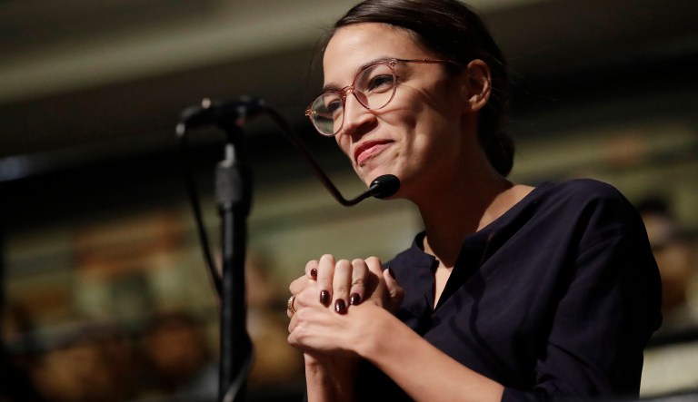 Democrat Alexandria Ocasio-Cortez, who won her bid for a seat in the House of Representatives in New York's 14th Congressional District, asks 2014 Nobel Laureate Malala Yousafzai a question at the Kennedy School's Institute of Politics at Harvard University in Cambridge, Mass., Thursday, Dec. 6, 2018.