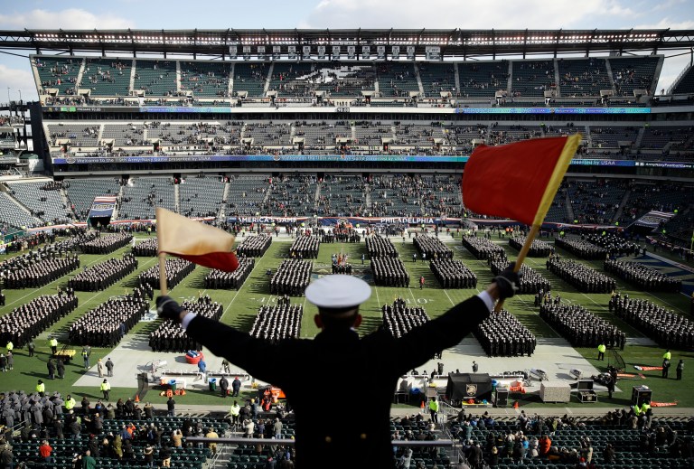 Navy Midshipman Frey Pankratz singles his classmates as they march onto the field ahead of an NCAA college football against the Army, Saturday, Dec. 8, 2018, in Philadelphia.