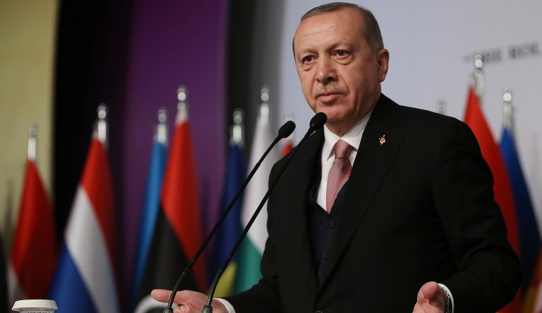 Turkish President Recep Tayyip Erdogan addresses a judicial conference of Organisation of Islamic Cooperation in Istanbul, Friday, Dec. 14, 2018. Erdogan intensified his criticism over U.S. support for Syrian Kurdish fighters, saying Friday Turkey would clear the key northern Syrian town of Manbij.