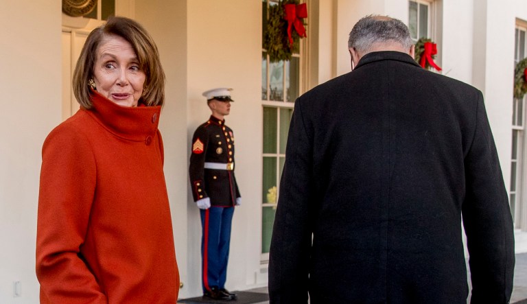 In this Dec. 11, 2018, photo, House Minority Leader Nancy Pelosi, D-Calif., speaks to a reporter as she and Senate Minority Leader Sen. Chuck Schumer, D-N.Y., walk back into the West Wing after speaking to members of the media outside of the White House in Washington.