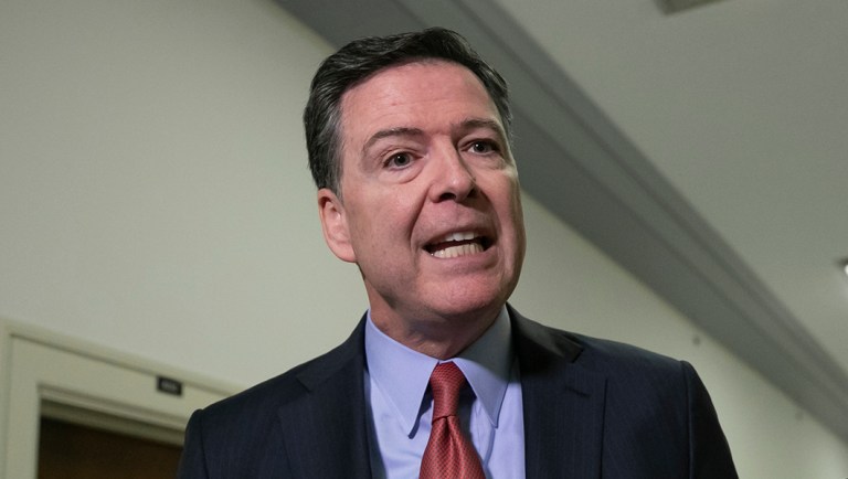 Former FBI Director James Comey speaks to reporters on Capitol Hill.