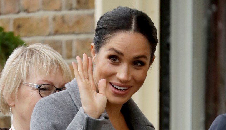 Meghan, Duchess of Sussex waves as she arrives to visit the Royal Variety Charity's residential nursing and care home Brinsworth House, in Twickenham, southwest London.