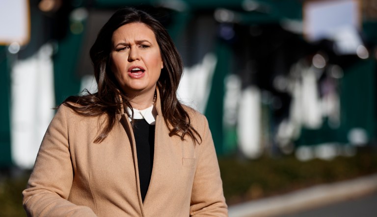 White House press secretary Sarah Sanders talks with reporters outside the White House, Tuesday, Dec. 18, 2018.