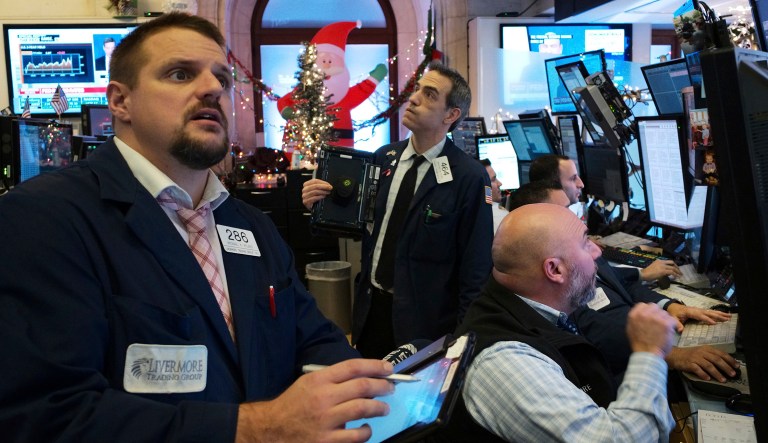 Traders with Livermore Securities at the New York Stock Exchange follow the news from the Federal Reserve Board of a rate increase, Wednesday, Dec. 19, 2018.