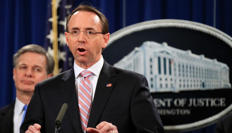 Deputy Attorney General Rod Rosenstein, with FBI Director Christopher Wray, speaks during a news conference at the Department of Justice in Washington, Thursday, Dec. 20, 2018.