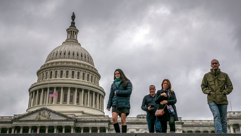 People arrive at the Capitol Visitors Center as work in Congress continues prior to a Friday night funding deadline to avoid a partial government shutdown, in Washington.