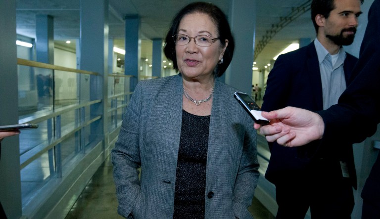 Sen. Mazie Hirono, D-Hawaii, speaks to reporters on his way to her office, as the Senate takes up a House-passed bill that would pay for President Donald Trump's border wall and avert a partial government shutdown, at the Capitol in Washington, Friday, Dec. 21, 2018.