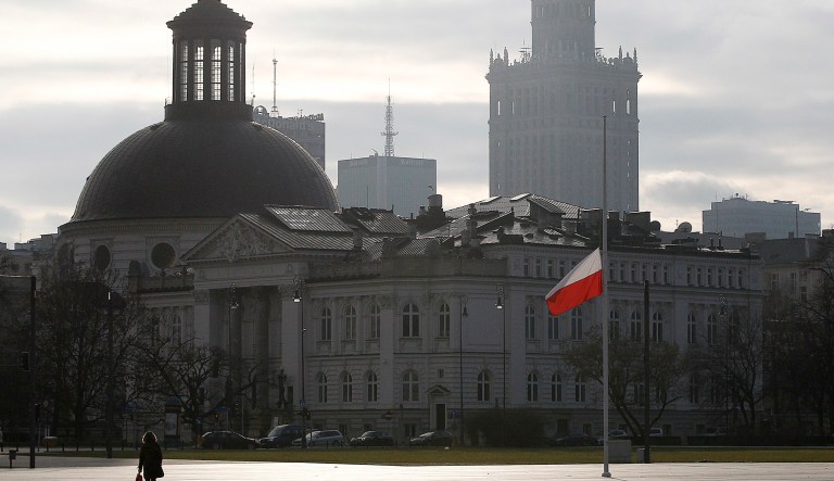 A Polish flag is set on half staff in Warsaw, Poland, Sunday, Dec. 23, 2018 during a day of national mourning in Poland for 12 Polish miners killed in an accident in a Czech coal mine on Thursday, Dec. 21, 2018.