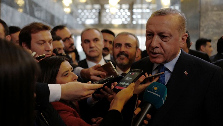 Turkey's President Recep Tayyip Erdogan speaks to reporters at the parliament in Ankara.