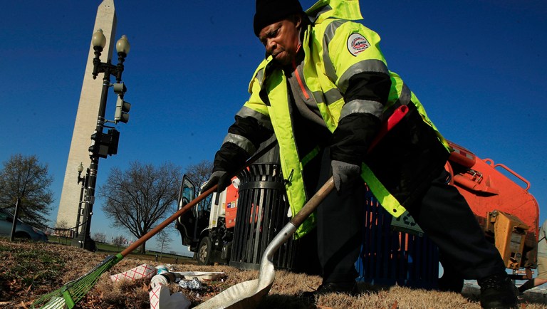 Jimmy Taylor of the Department of Public Works collects trash at the National Mall in Washington.