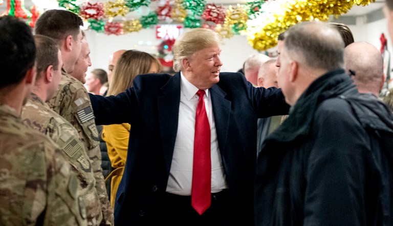 President Trump visits with members of the military at a dining hall at al-Asad Air Base, Iraq, Wednesday, Dec. 26, 2018. 
