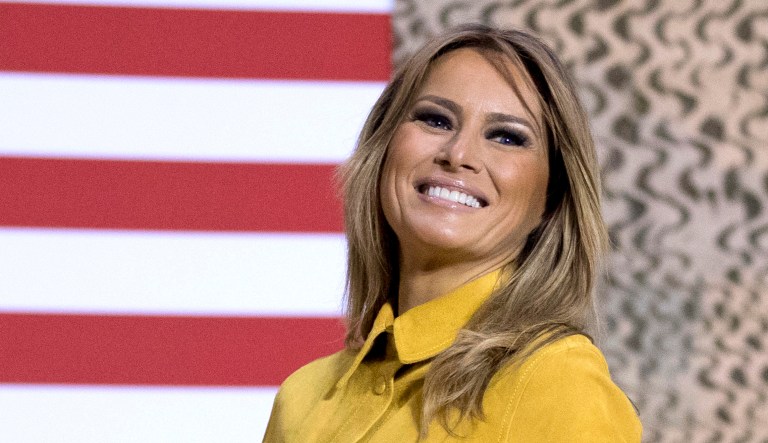 First lady Melania Trump smiles as she steps away from the podium after speaking.
