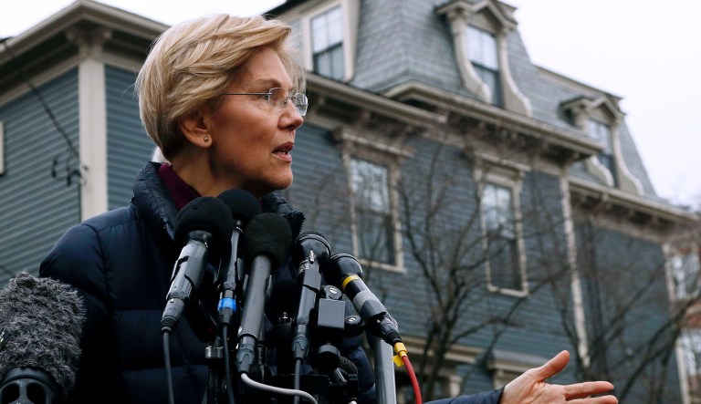 Sen. Elizabeth Warren, D-Mass., speaks outside her home, Monday, Dec. 31, 2018, in Cambridge, Mass.