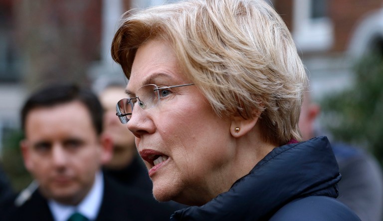 Sen. Elizabeth Warren, D-Mass., speaks outside her home, Monday, Dec. 31, 2018, in Cambridge, Mass. Warren on Monday took the first major step toward launching a widely anticipated campaign for the presidency, hoping her reputation as a populist fighter can help her navigate a Democratic field that could include nearly two dozen candidates.