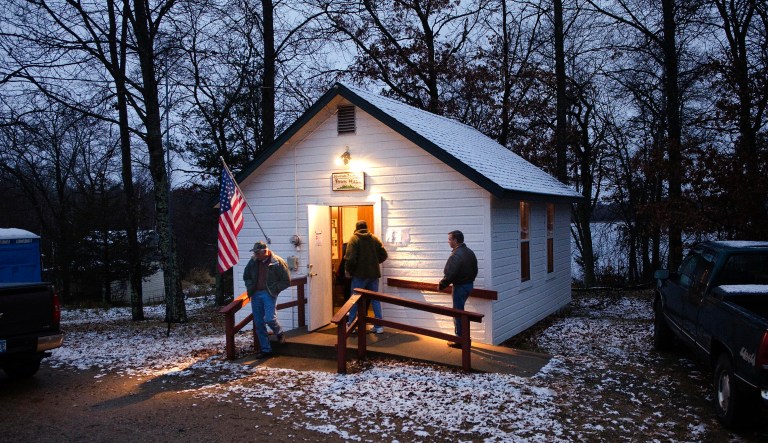 A light wet snow covers the roof and ground around the Jenkins Town Hall as early voters casts their ballots Tuesday, Nov. 6, 2012 in Jenkins, Minn.