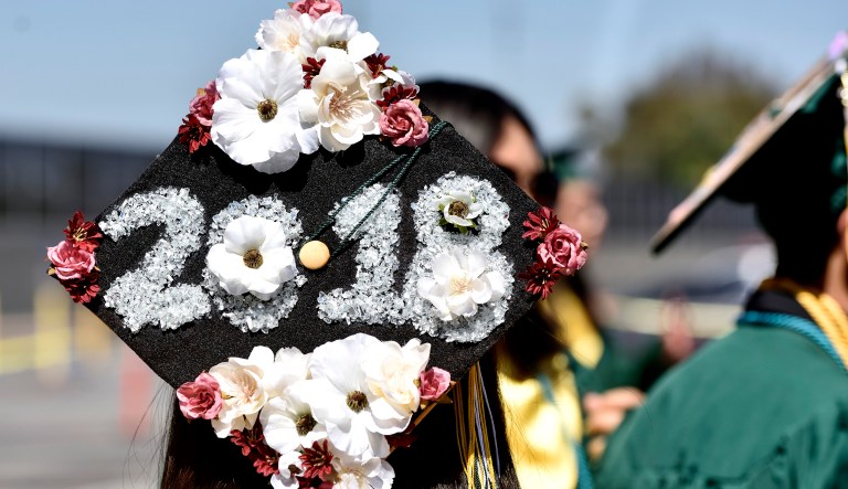 A graduate wears a decorated cap.