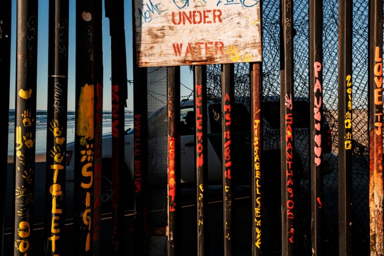 A border patrol office inside his vehicle guards the border fence at the U.S. side of San Diego, Calif., as seen from Tijuana, Mexico, Wednesday, Jan. 2, 2019.