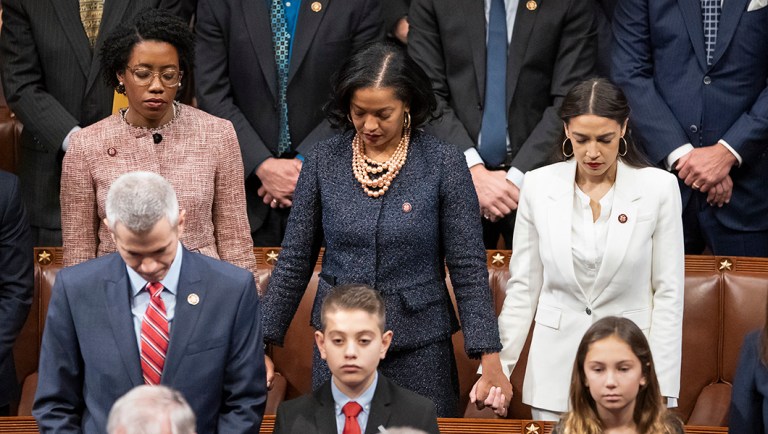 Rep. Lauren Underwood, D-Ill., Rep. Jahana Hayes, D-Conn., and Rep. Alexandria Ocasio-Cortez, D-N.Y, hold hands during an opening prayer.