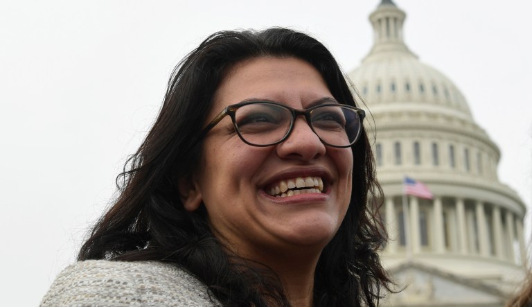 Rep. Rashida Tlaib, D-Mich., smiles following a group photo with the women in the House of Representatives on Capitol Hill in Washington, Friday, Jan. 4, 2019, during the opening session of the 116th Congress.