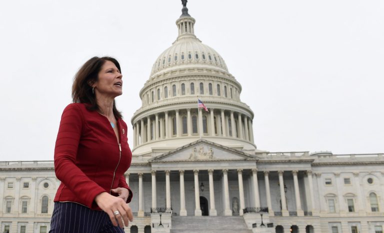 Rep. Cheri Bustos, D-Ill., walks to a group photo with the women of the 116th Congress on Capitol Hill in Washington, Friday, Jan. 4, 2019. 