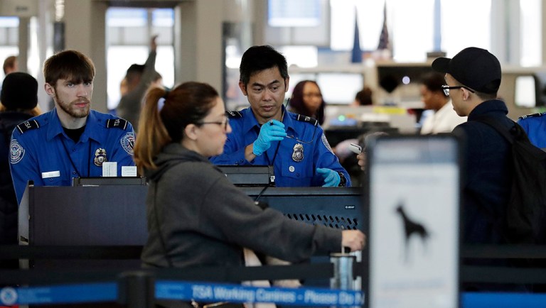 Transportation Security Administration officers work at a checkpoint at O'Hare airport in Chicago, Saturday, Jan. 5, 2019.