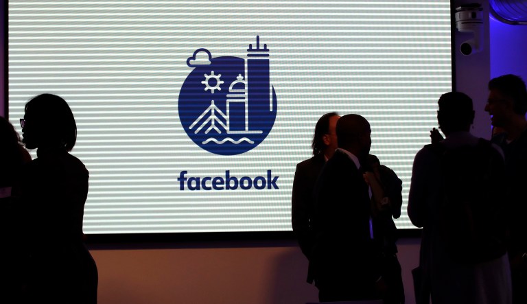 In this Jan. 9, 2019 photo, media and guests mingle before a tour of Facebook's new 130,000-square-foot offices, which occupy the top three floors of a 10-story Cambridge, Mass. building.