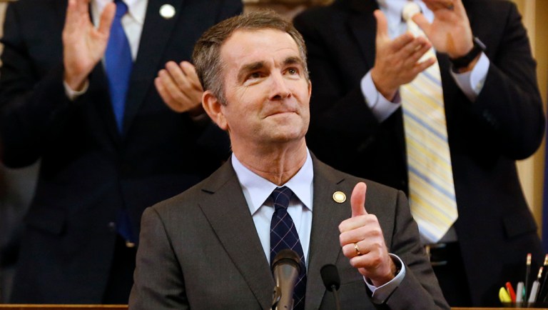 Virginia Gov. Ralph Northam, center, gives a thumbs-up.