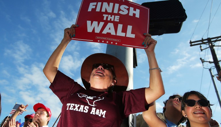 Supporters react during a visit by President Trump at McAllen Miller International Airport in McAllen, Texas, Thursday, Jan. 10, 2019, in McAllen, Texas.