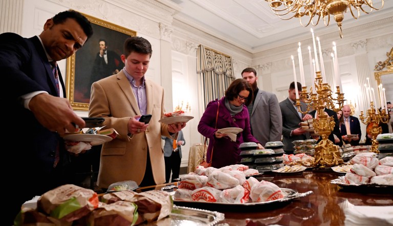 Guests attending a reception for the Clemson Tigers grab fast food sandwiches in the State Dining Room of the White House in Washington, D.C.
