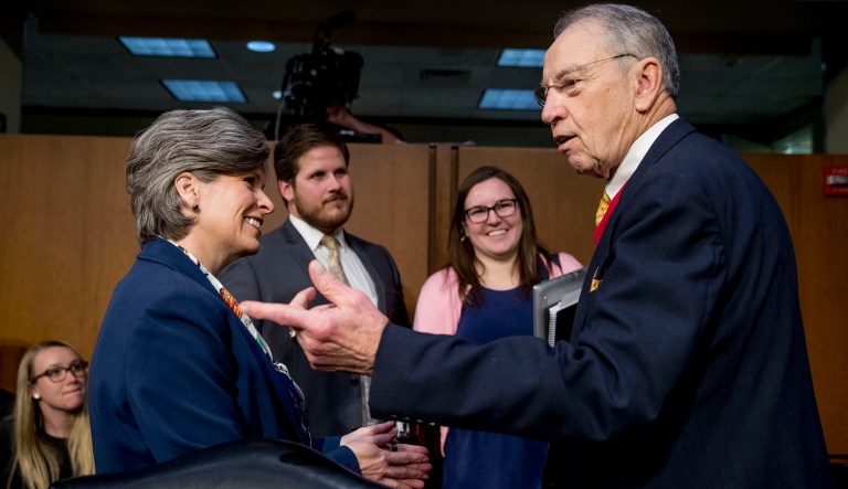 Sen. Joni Ernst, R-Iowa, left, speaks with Sen. Chuck Grassley, R-Iowa, right, at a Senate Judiciary Committee hearing for former Attorney General nominee William Barr on Capitol Hill in Washington, Tuesday, Jan. 15, 2019.  