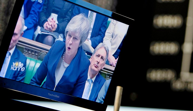 A computer screen shows news about Brexit with Prime Minister Theresa May.