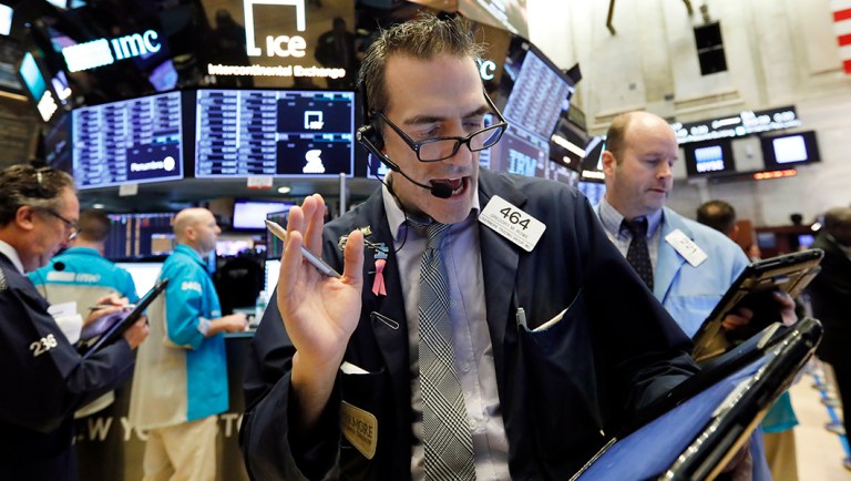 Trader Gregory Rowe works on the floor of the New York Stock Exchange.