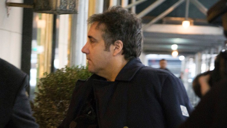Michael Cohen arrives at his home in New York with his left arm in a sling supported by a pillow Friday, Jan. 18, 2019. A Buzzfeed story alleging that President Trump directed Cohen to lie to Congress was discounted in a rare rebuke from the Russia special investigator.