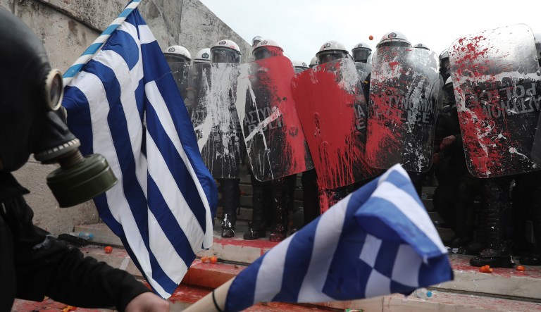 Greek riot police block the stairs leading to Parliament during clashes after a rally in Athens, Sunday, Jan. 20, 2019.