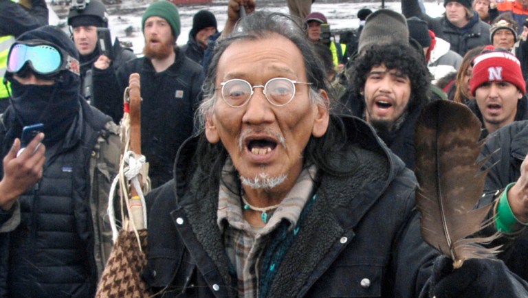 A large crowd representing a majority of the remaining Dakota Access Pipeline protesters, including Nathan Phillips, center with glasses, march out of the Oceti Sakowin camp before the deadline set for evacuation of the camp near Cannon Ball, N.D.