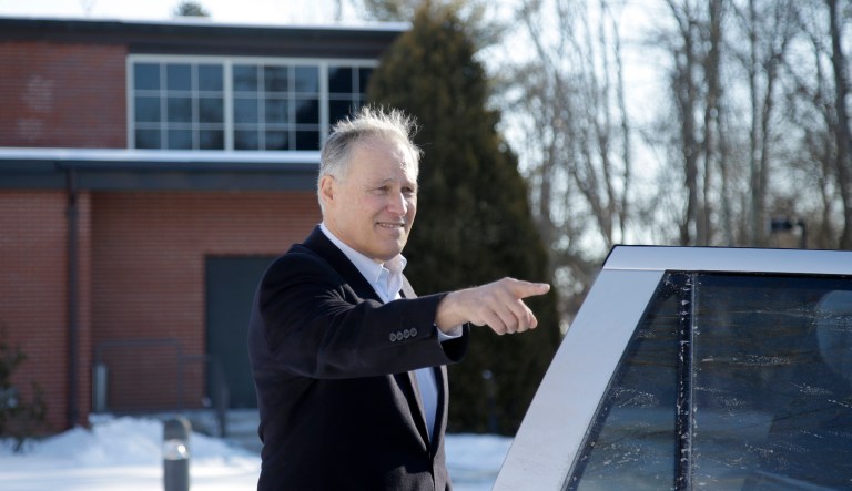 Washington Gov. Jay Inslee points as he steps into his car after speaking at Saint Anselm College, Tuesday, Jan. 22, 2019, in Manchester, N.H.