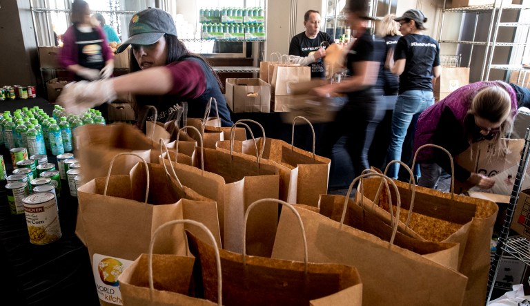 Volunteers, many of them furloughed government workers themselves, hand out food and supplies to furloughed government workers affected by the shutdown at World Central Kitchen, the not-for-profit organization started by Chef Jose Andres, Tuesday, Jan. 22, 2019 in Washington. The organization devoted to providing meals in the wake of natural disasters, has set up a distribution center just blocks from the U.S. Capitol building to assist those affected by the government shutdown.
