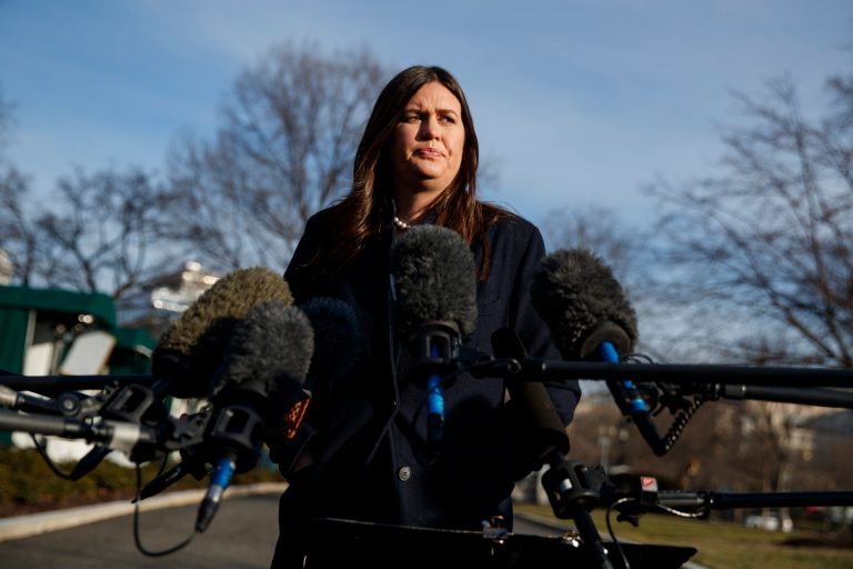 White House press secretary Sarah Sanders talks with reporters outside the White House, Friday, Jan. 25, 2019, in Washington.