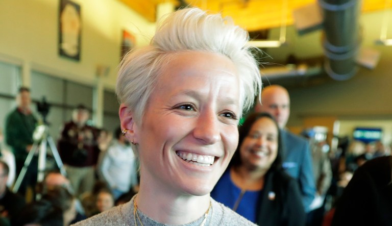 Megan Rapinoe arrives for a news conference .