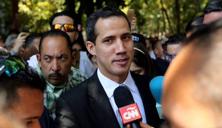 Opposition National Assembly President Juan Guaido talks with reporters upon his arrival to the Venezuelan Central University for a conference on economic plans for reviving the country in Caracas, Venezuela.