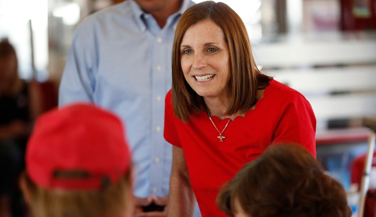 FILE - In this Nov. 6, 2018, file photo, then-Arizona Republican senatorial candidate Martha McSally, speaks with voters, at Chase's diner in Chandler, Ariz. he Federal Election Commission says Arizona Sen. Martha McSally may have accepted $270,000 in campaign contributions that exceeded legal limits. Federal candidates can collect $2,700 from a single donor during a primary election and an additional $2,700 from that same person during the general. But agency flagged dozens of contributions to McSally that appear to exceed those limits. 