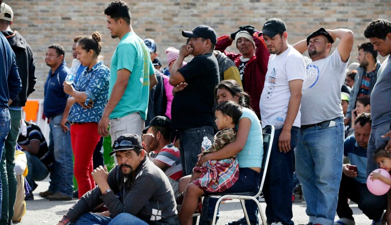 Central American immigrants line up to register with Mexican immigration officials at a shelter in Piedras Negras, Mexico.