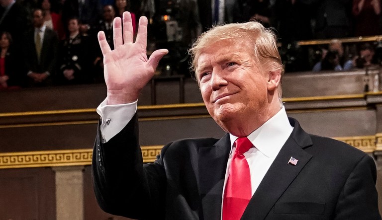 President Trump waves as he gives the State of the Union address.