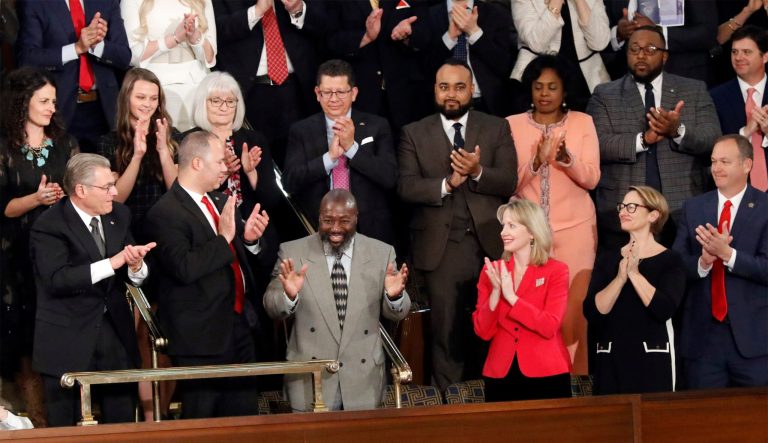 Matthew Charles, center, gestures as President Donald Trump acknowledges him during the State of the Union address to a joint session of Congress on Capitol Hill in Washington, Tuesday, Feb. 5, 2019.