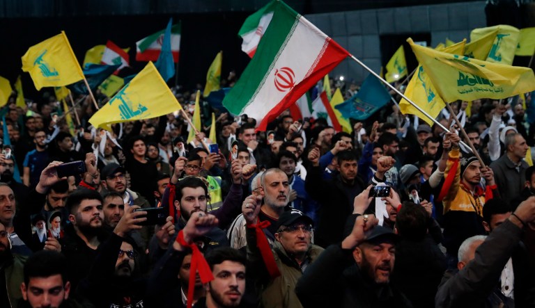 Hezbollah supporters shout slogans and wave Lebanese, Hezbollah and Iran flags, during a rally to commemorate the 40th anniversary of Iran's Islamic Revolution, in southern Beirut, Lebanon, Wednesday.